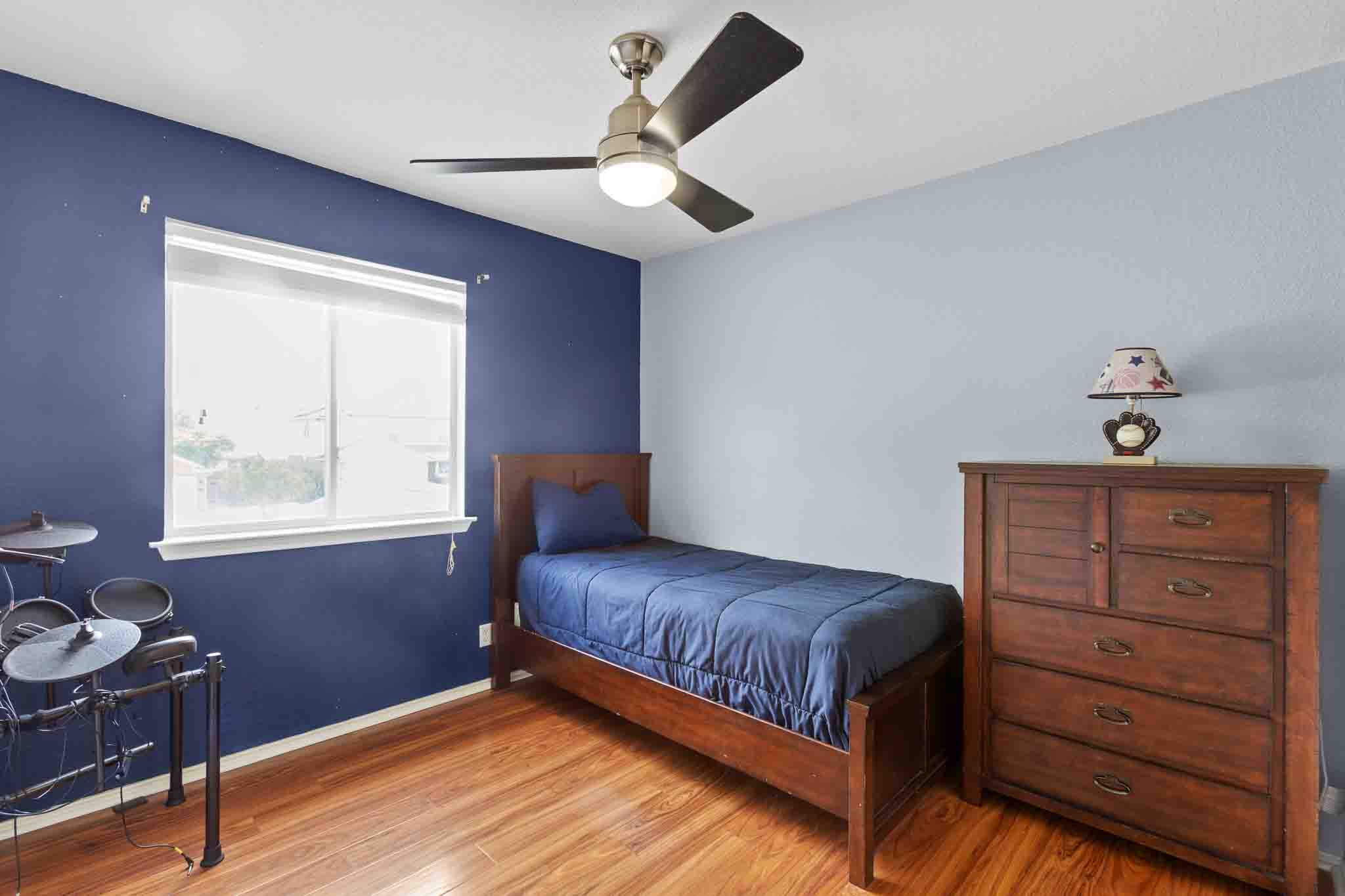 270 Endeavour Kyle, TX 78640 - Photo 14 of 20 The room features wood flooring, a window providing natural light, and a ceiling fan with integrated lighting