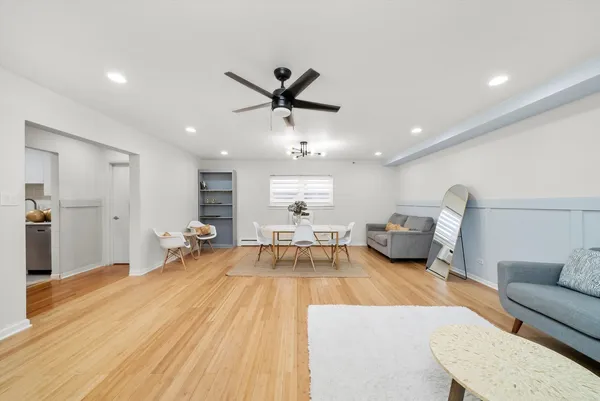a living room with furniture and a wooden floor