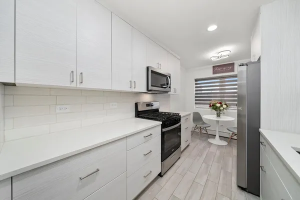 a kitchen with a sink appliances and cabinets