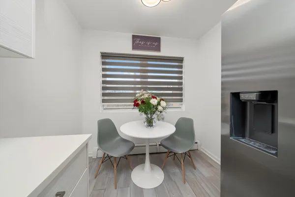 a dining room with furniture and wooden floor