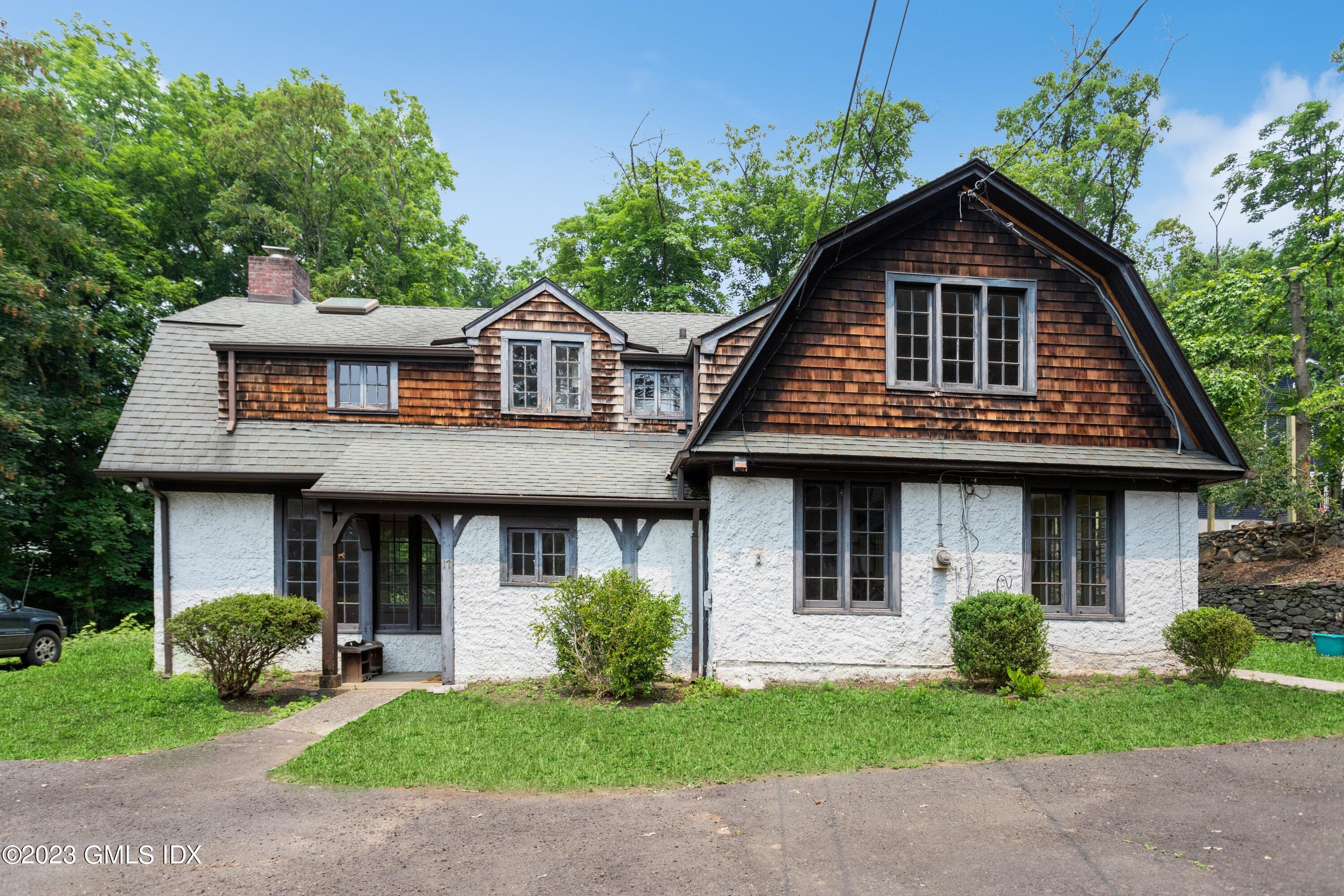 17 Buxton Lane Riverside, CT 06878 - Photo 2 of 22 a front view of a house with a yard
