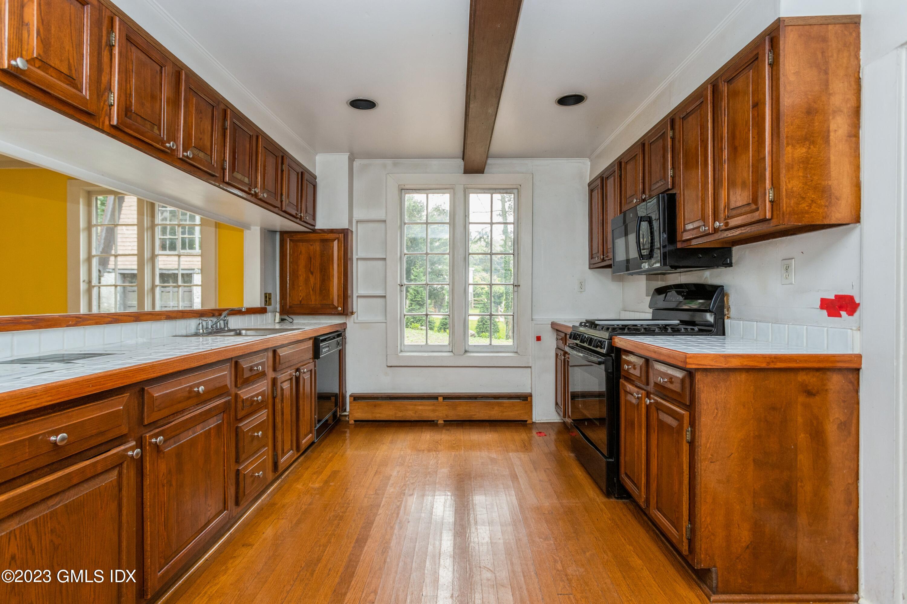 17 Buxton Lane Riverside, CT 06878 - Photo 6 of 22 a kitchen with stainless steel appliances granite countertop a stove a sink and a refrigerator