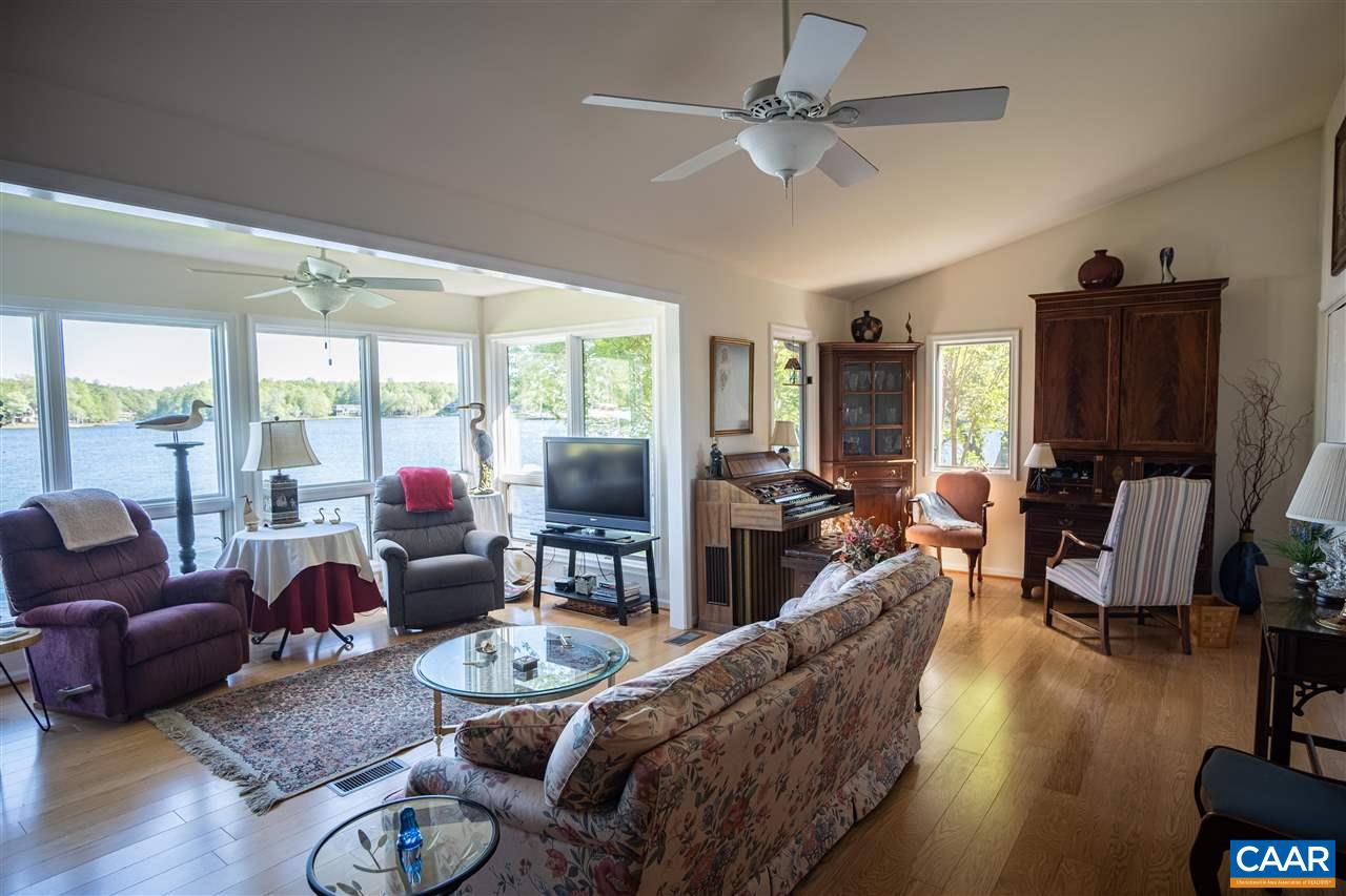 1 Marina Point, Unit B1 Palmyra, VA 22963 - Photo 13 of 31 a living room with furniture a flat screen tv and a large window