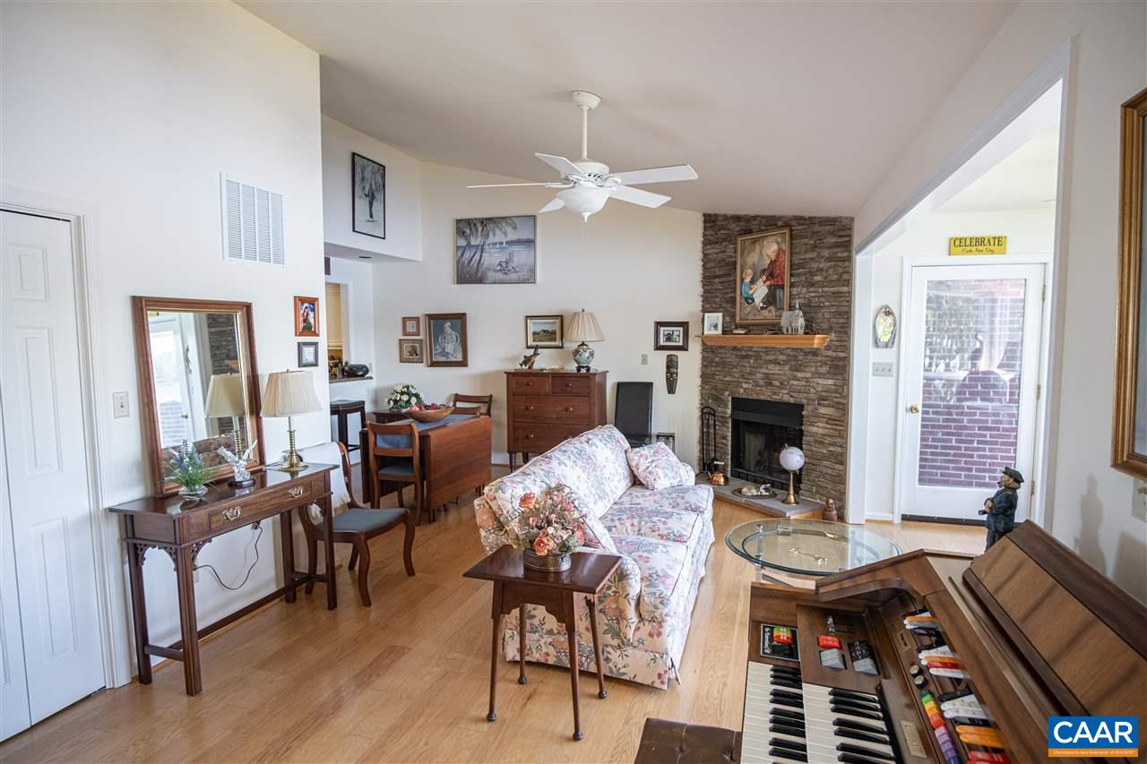 1 Marina Point, Unit B1 Palmyra, VA 22963 - Photo 14 of 31 a living room with furniture a fireplace and a flat screen tv