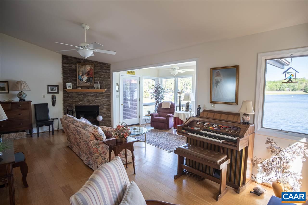 1 Marina Point, Unit B1 Palmyra, VA 22963 - Photo 15 of 31 a living room with furniture a fireplace and a flat screen tv
