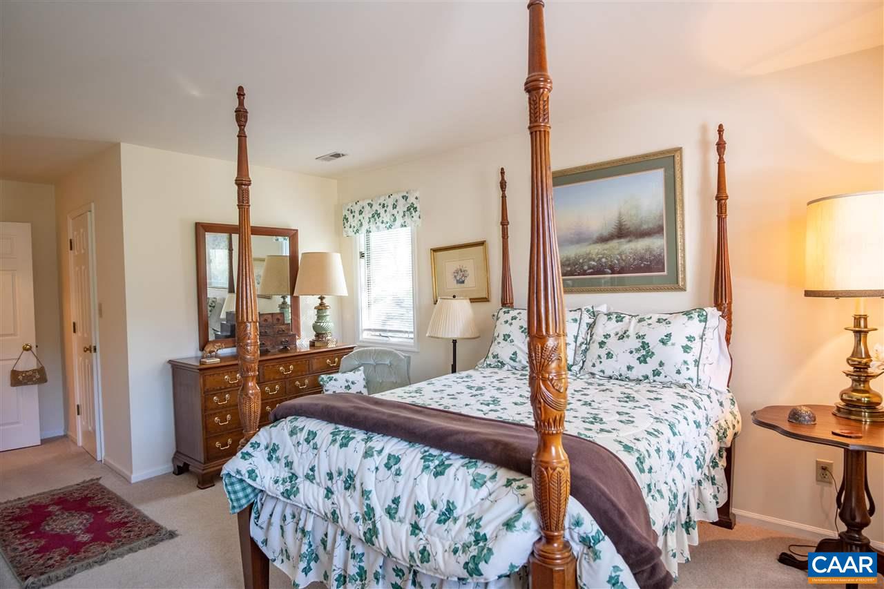 1 Marina Point, Unit B1 Palmyra, VA 22963 - Photo 21 of 31 a bedroom with a bed and dresser with mirror