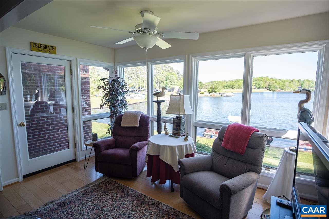 1 Marina Point, Unit B1 Palmyra, VA 22963 - Photo 6 of 31 a living room with furniture and a floor to ceiling window