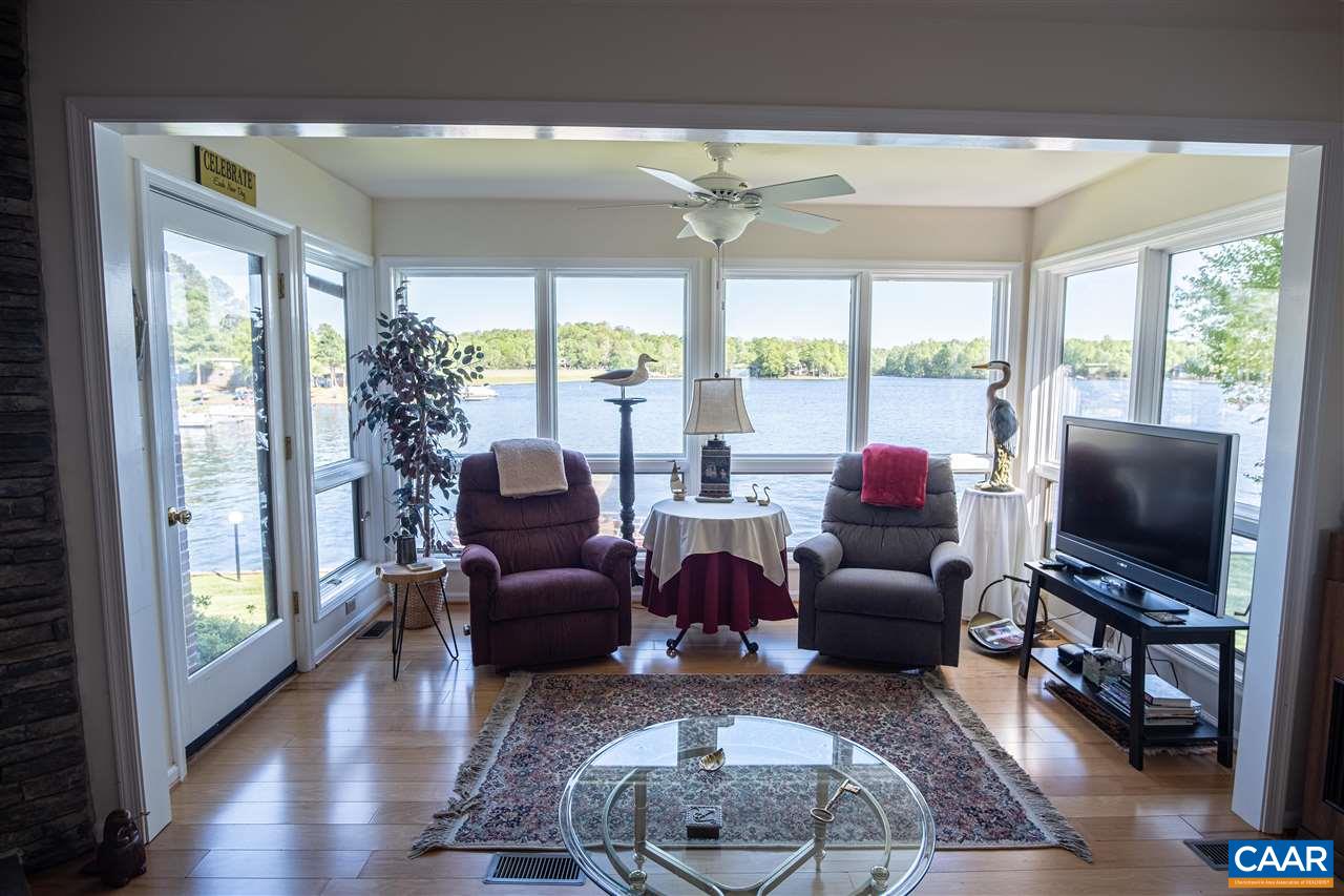 1 Marina Point, Unit B1 Palmyra, VA 22963 - Photo 8 of 31 a living room with furniture a flat screen tv and a floor to ceiling window