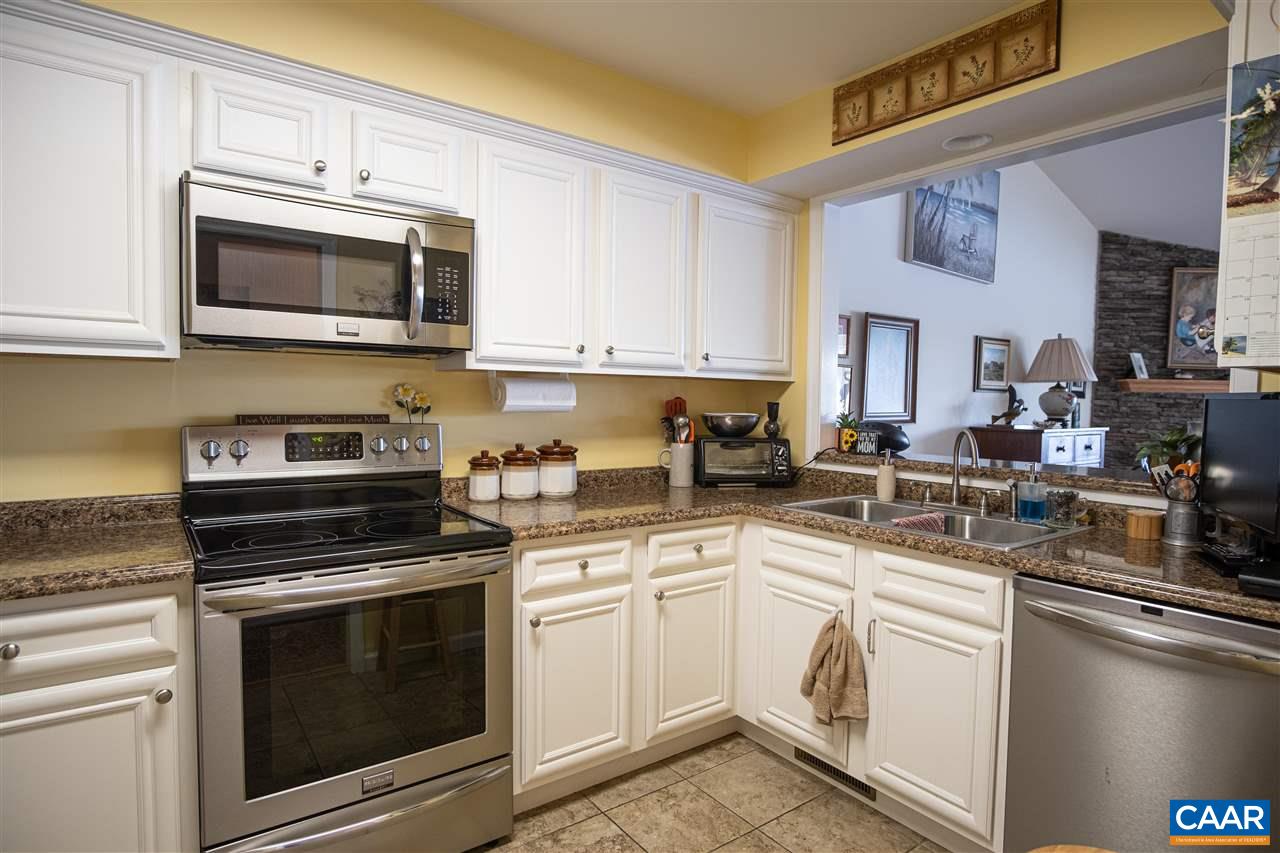 1 Marina Point, Unit B1 Palmyra, VA 22963 - Photo 9 of 31 a kitchen with white cabinets and stainless steel appliances