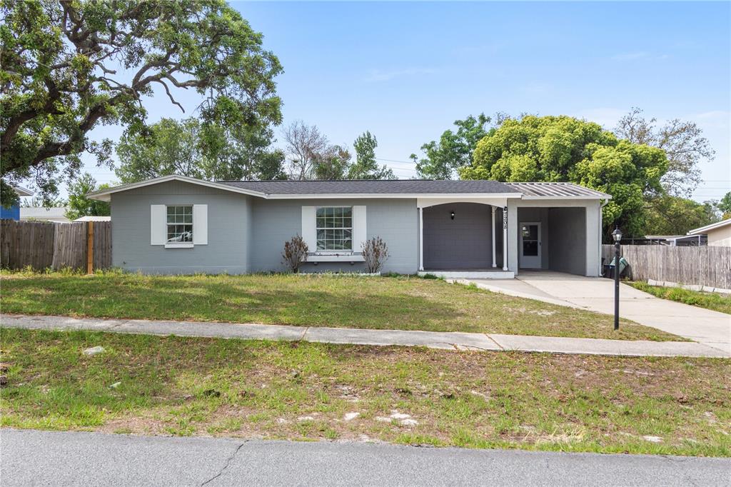 7208 Fair Oaks Street Spring Hill, FL 34606 - Photo 1 of 25 a house view with a garden space
