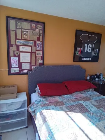 a bedroom with a bed and a view of bathroom