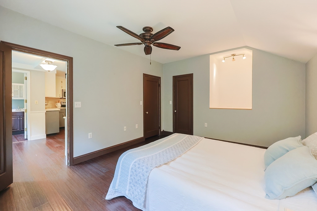 76 Ray Road Wrentham, MA 02093 - Photo 29 of 42 a bedroom with a bed and a chandelier