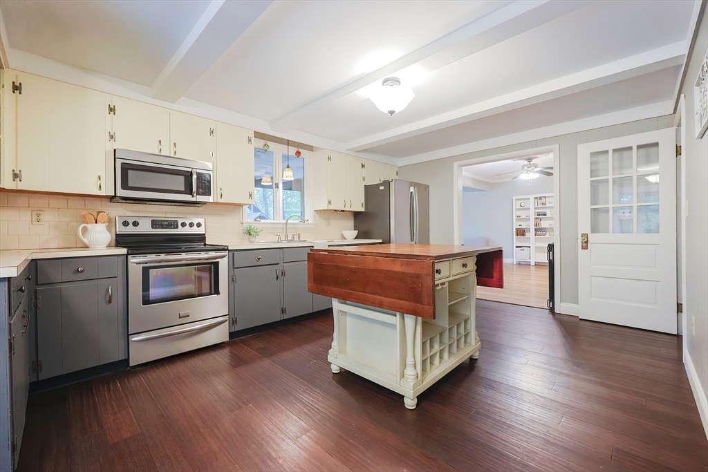 76 Ray Road Wrentham, MA 02093 - Photo 3 of 42 a kitchen with stainless steel appliances kitchen island wooden floors and white cabinets
