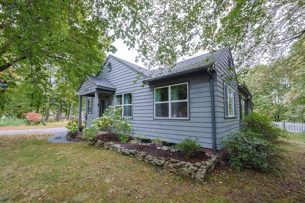 76 Ray Road Wrentham, MA 02093 - Photo 34 of 42 a brick house with a yard plants and large tree