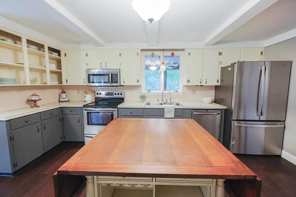 76 Ray Road Wrentham, MA 02093 - Photo 5 of 42 a kitchen with stainless steel appliances a refrigerator a stove a sink dishwasher and white cabinets with wooden floor