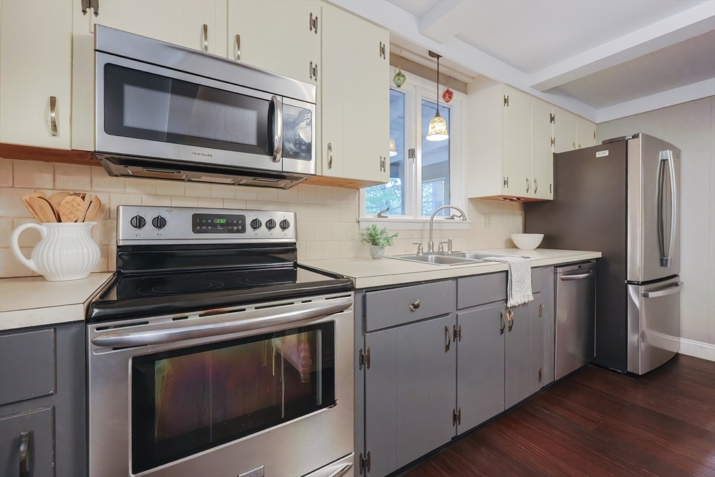 76 Ray Road Wrentham, MA 02093 - Photo 6 of 42 a kitchen with cabinets stainless steel appliances and wooden floor