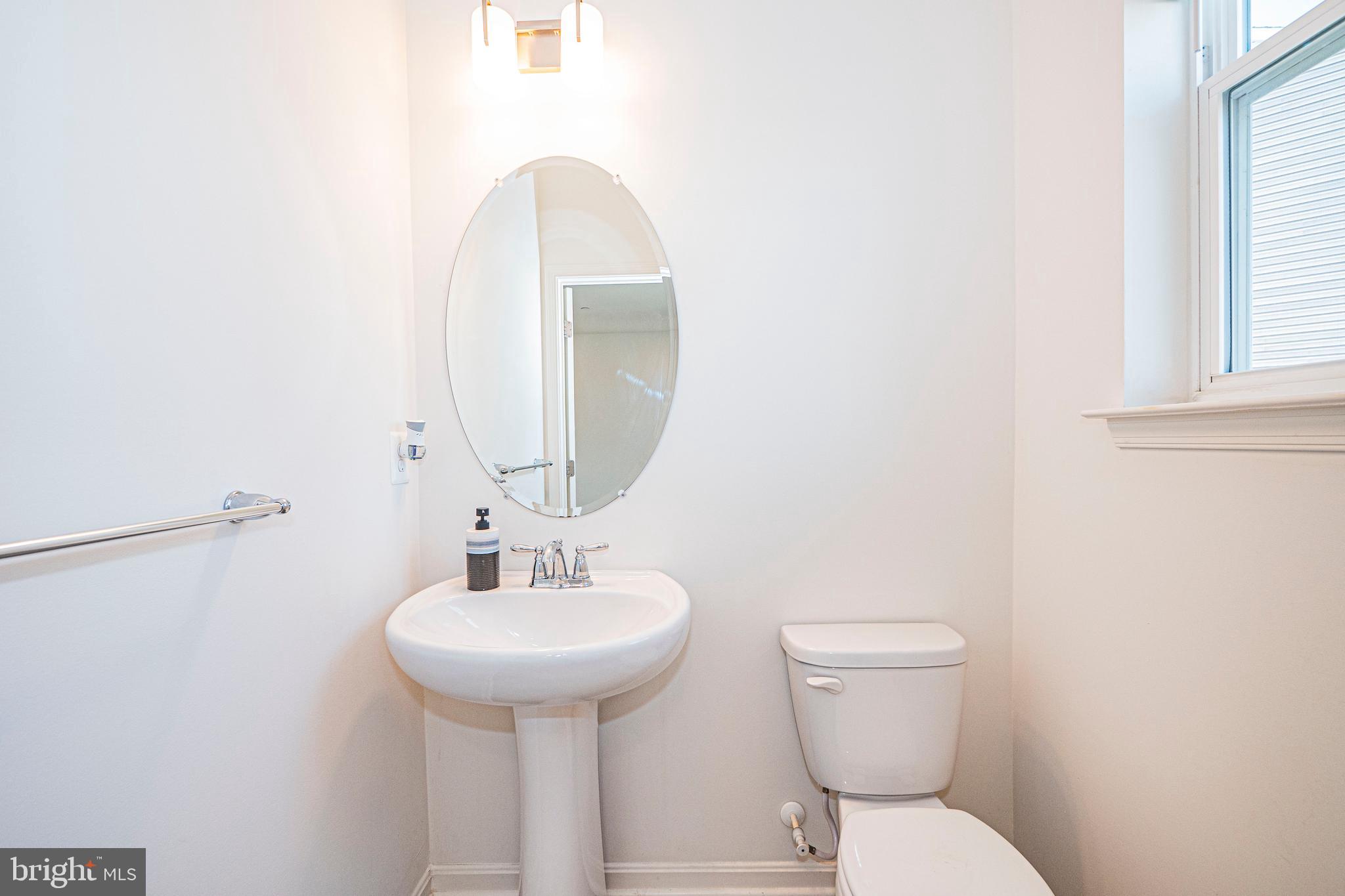 7315 Martin Farm Circle Rosedale, MD 21237 - Photo 15 of 46 a bathroom with a toilet sink and mirror
