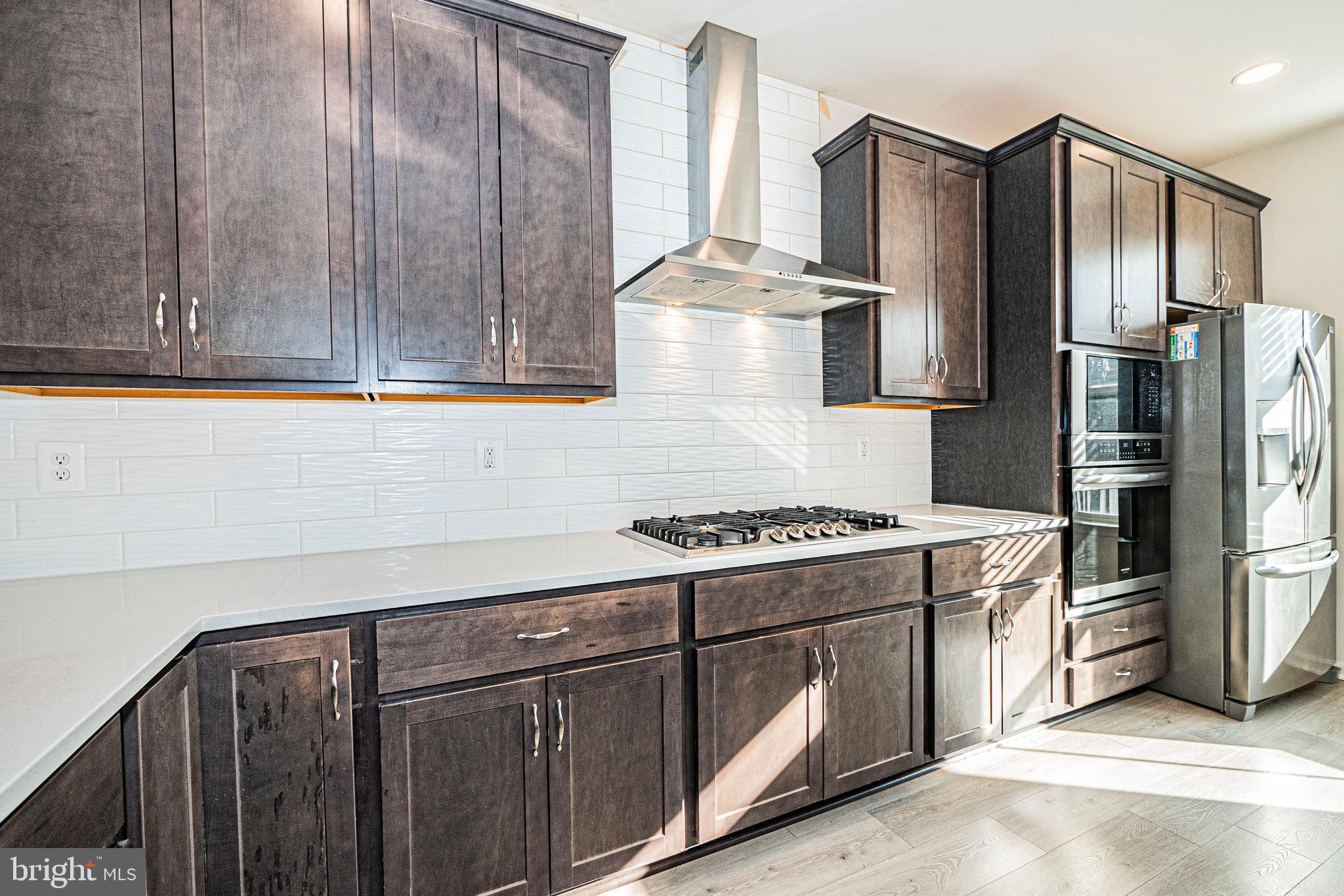 7315 Martin Farm Circle Rosedale, MD 21237 - Photo 22 of 46 a kitchen with stainless steel appliances granite countertop a refrigerator stove and cabinets