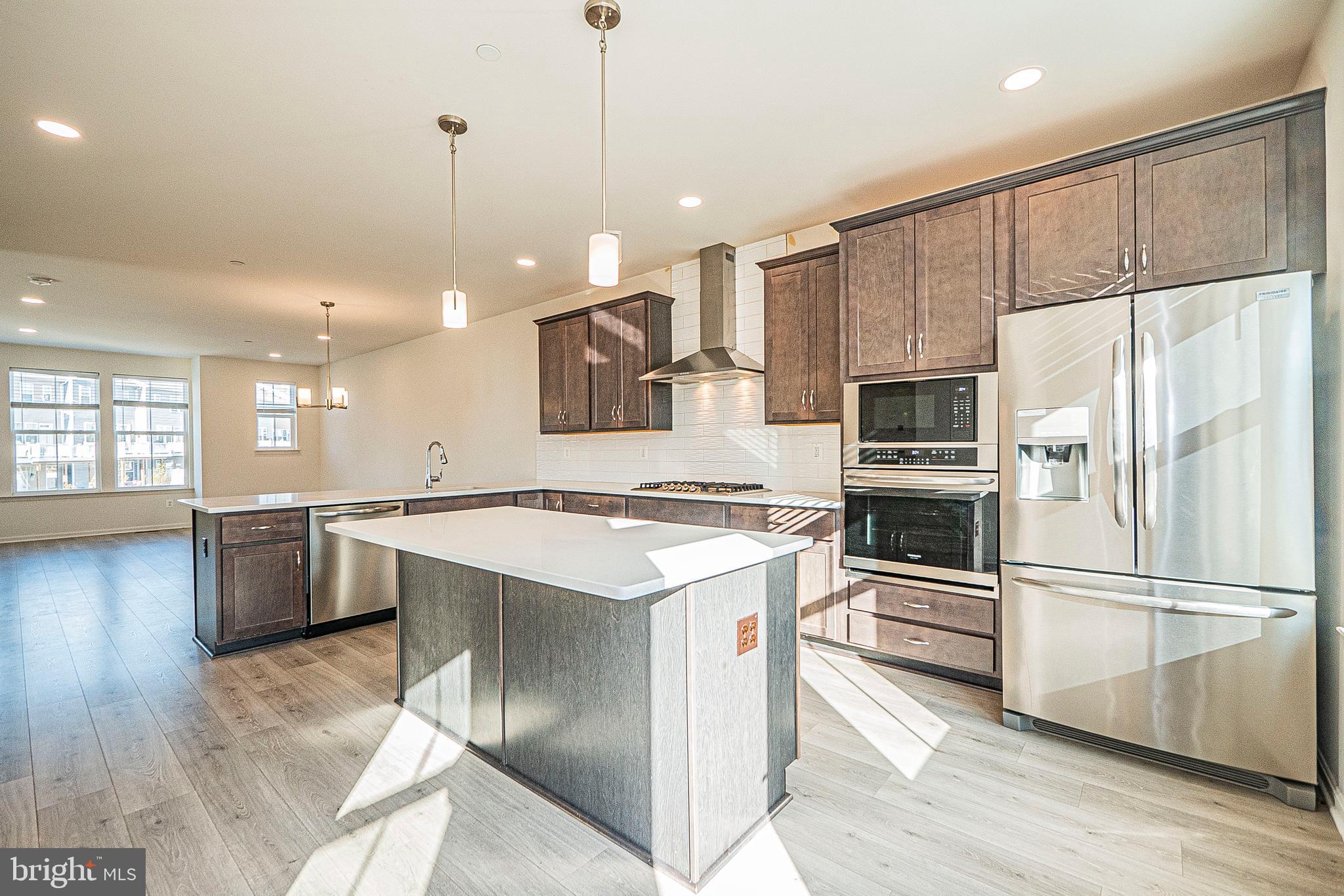 7315 Martin Farm Circle Rosedale, MD 21237 - Photo 23 of 46 a kitchen with kitchen island white cabinets and stainless steel appliances