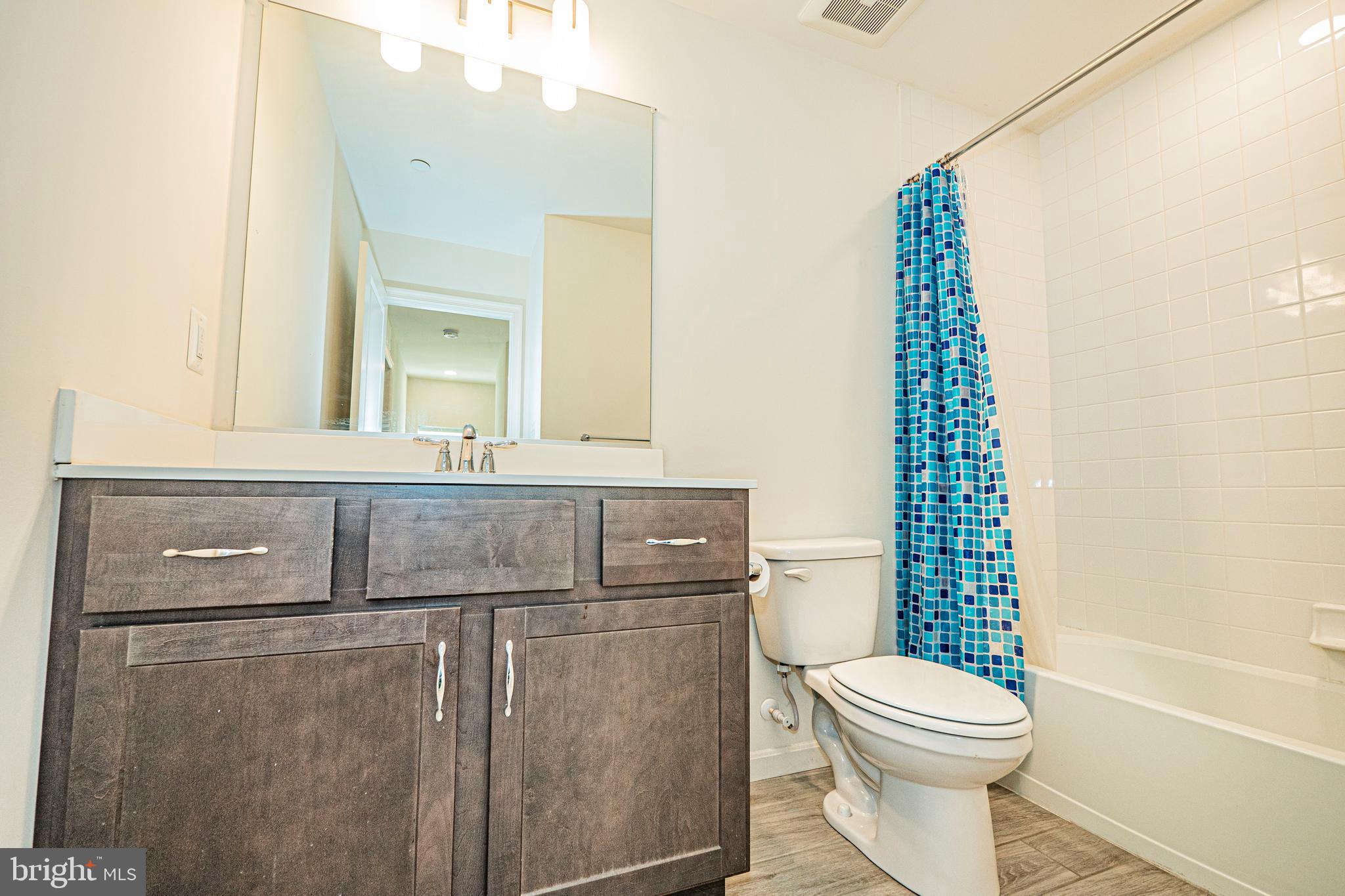 7315 Martin Farm Circle Rosedale, MD 21237 - Photo 29 of 46 a bathroom with a sink a toilet and shower