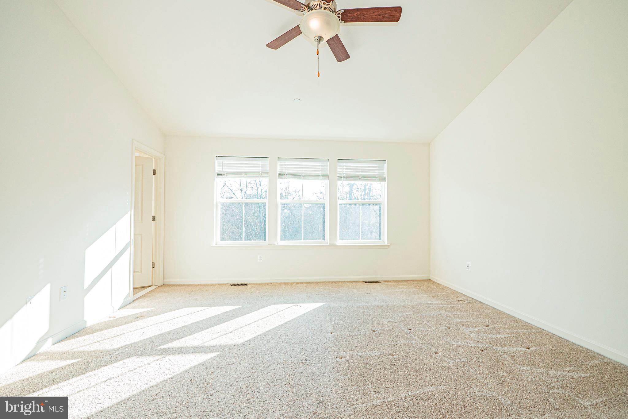 7315 Martin Farm Circle Rosedale, MD 21237 - Photo 36 of 46 an empty room with a window and ceiling fan