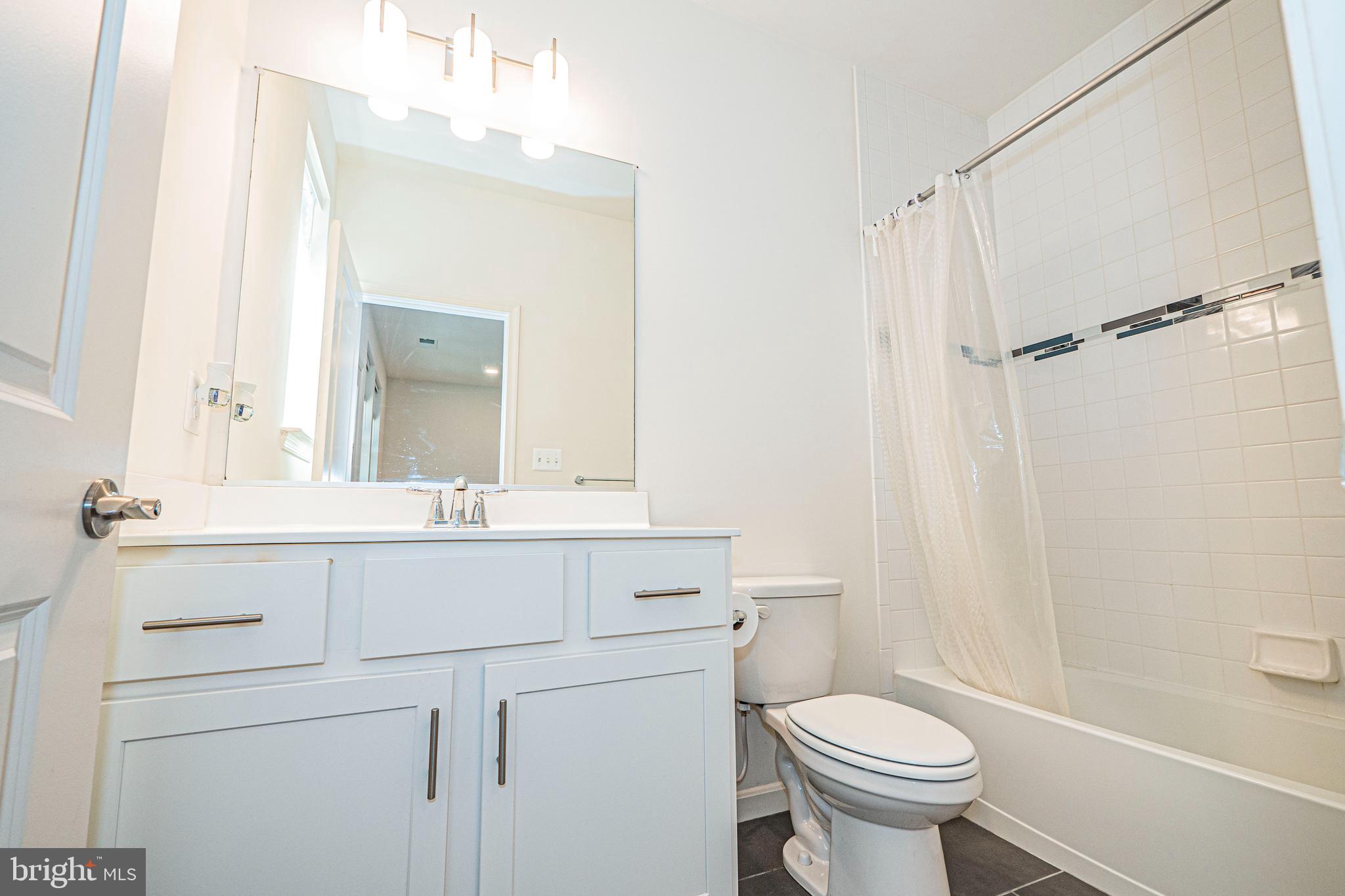 7315 Martin Farm Circle Rosedale, MD 21237 - Photo 4 of 46 a bathroom with a sink toilet and shower