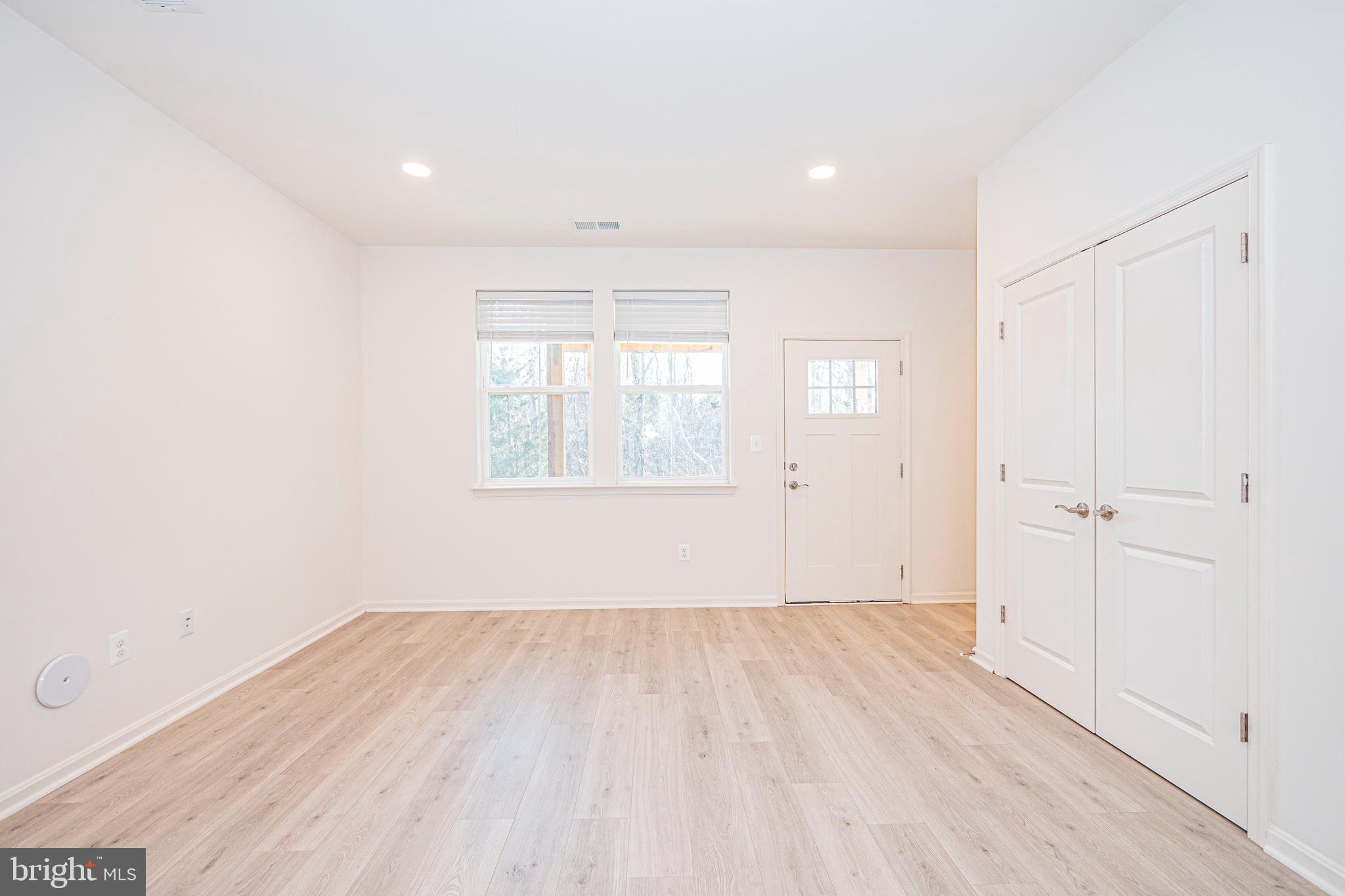 7315 Martin Farm Circle Rosedale, MD 21237 - Photo 7 of 46 a view of an empty room with wooden floor and a window