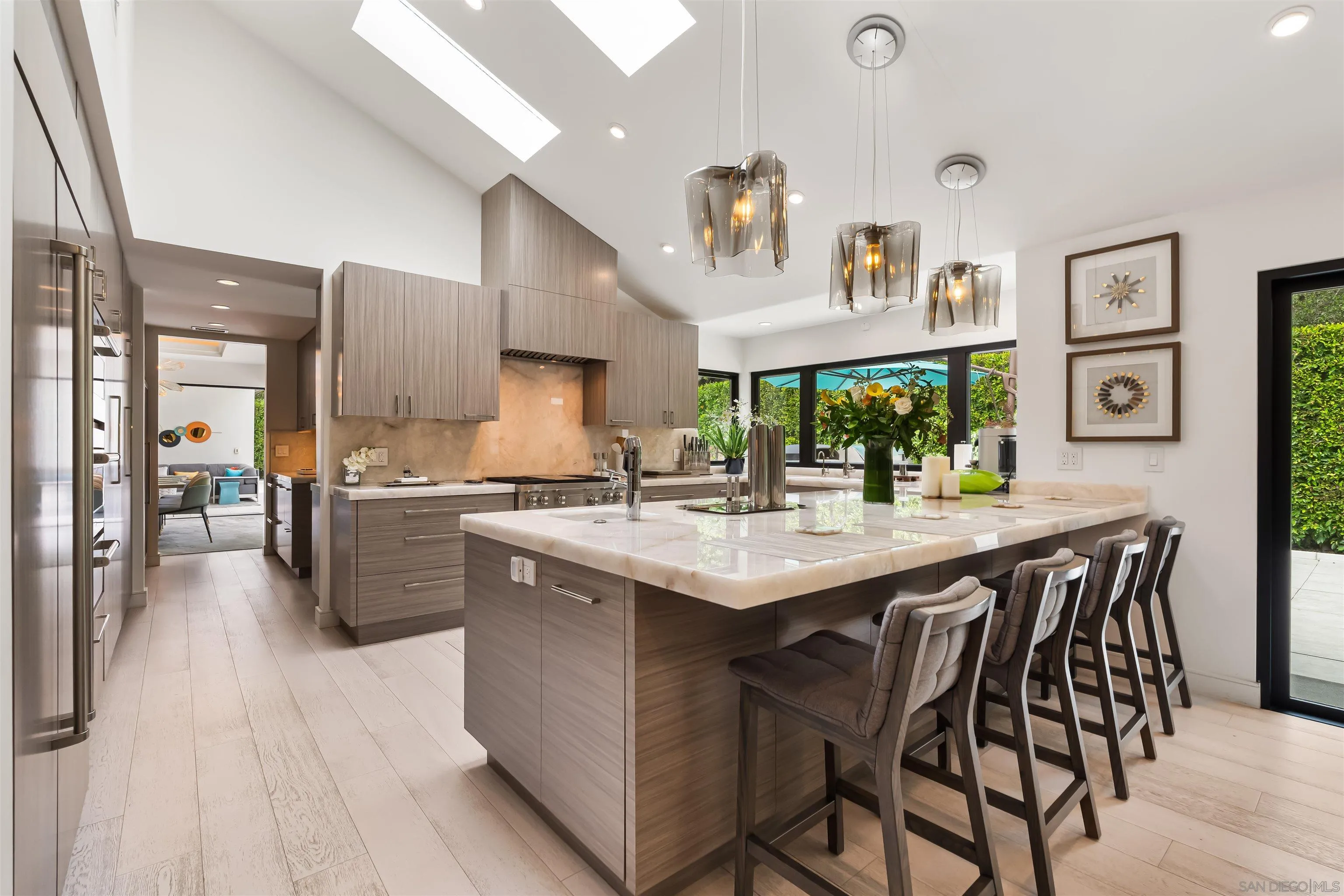 6887 Avenida Andorra La Jolla, CA 92037 - Photo 15 of 75 a kitchen with stainless steel appliances kitchen island a chandelier and wooden cabinets