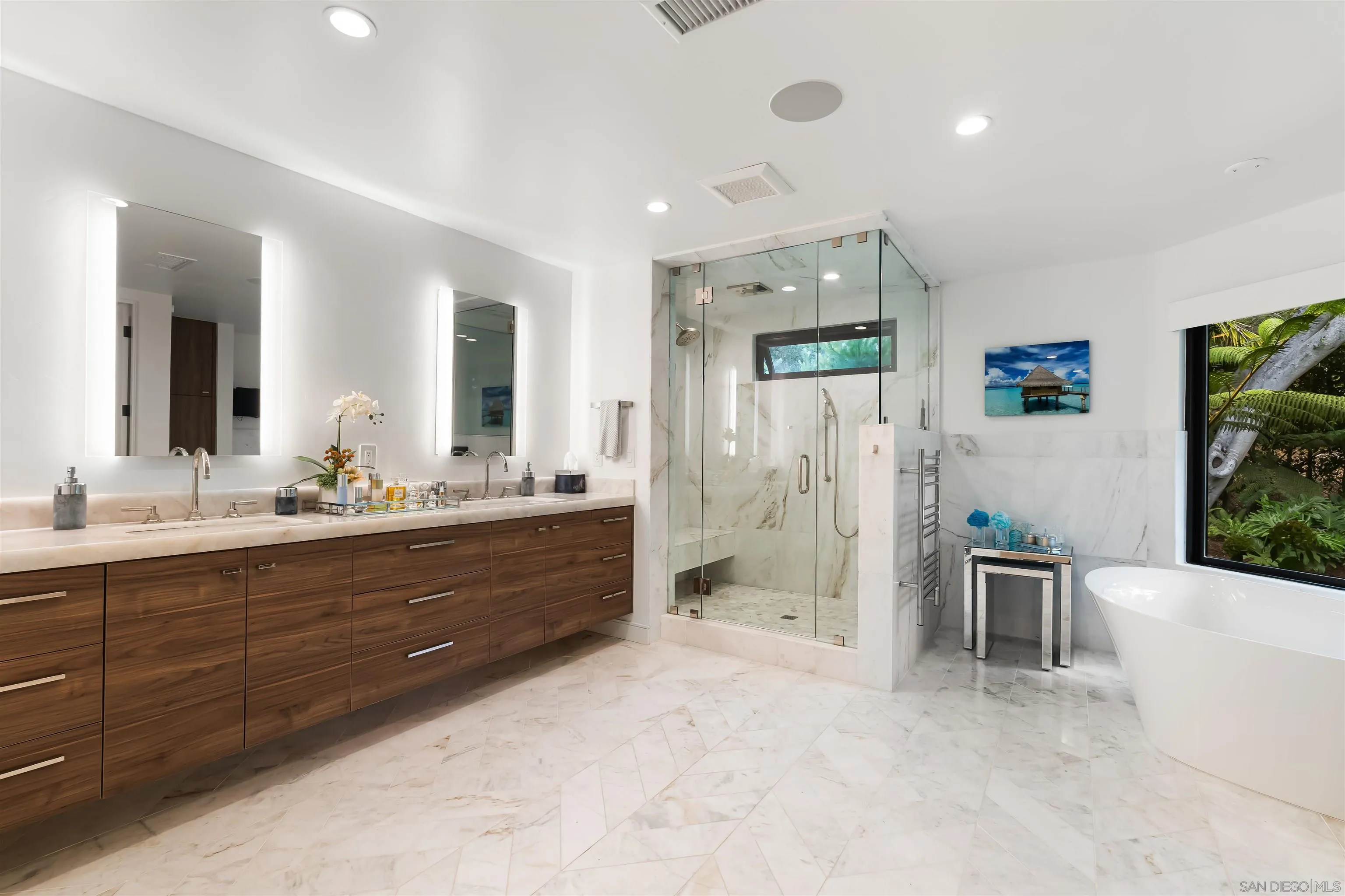 6887 Avenida Andorra La Jolla, CA 92037 - Photo 44 of 75 a spacious bathroom with a double vanity sink a large mirror and a bathtub