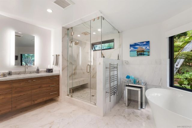 a bedroom with bed and a large window