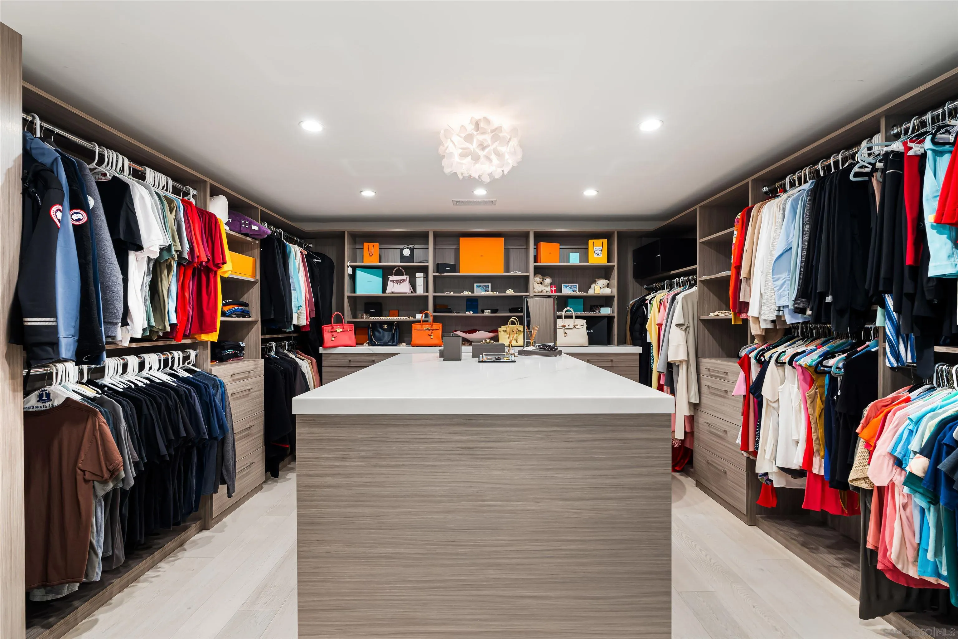 6887 Avenida Andorra La Jolla, CA 92037 - Photo 47 of 75 a view of walk in closet with clothes and shoes