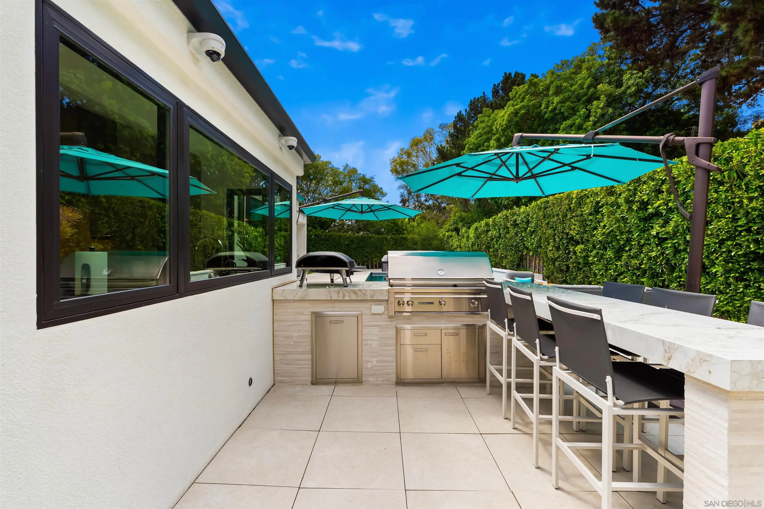 6887 Avenida Andorra La Jolla, CA 92037 - Photo 59 of 75 a view of a patio with a table and chairs under an umbrella