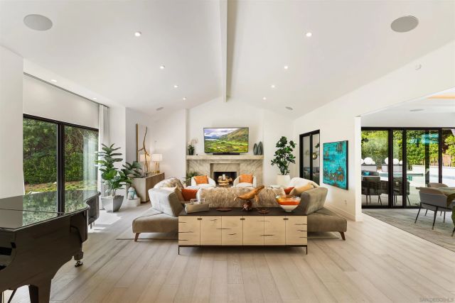 a living room with furniture potted plant and a large window