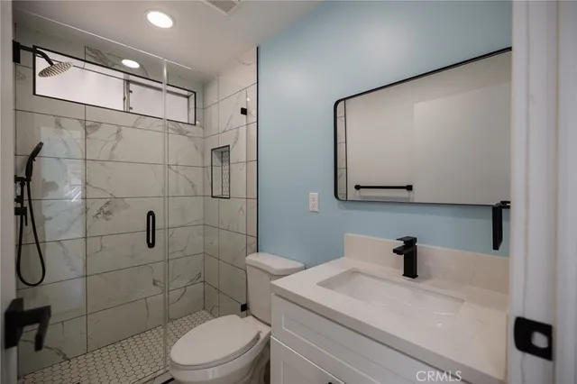 a bathroom with a toilet sink and shower
