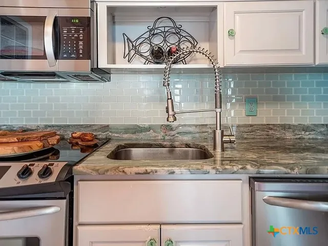 a kitchen with a stove and a sink