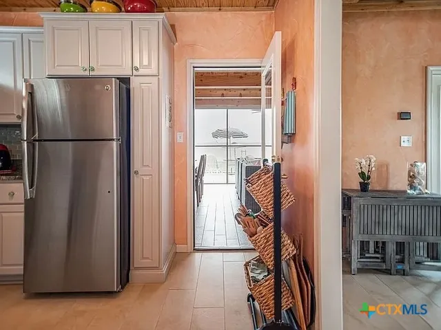 a view of kitchen with furniture and refrigerator