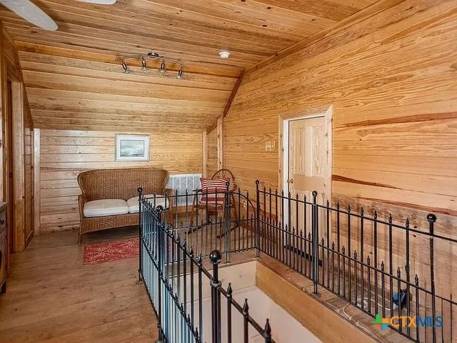 a spacious bedroom with a bed and wooden floor