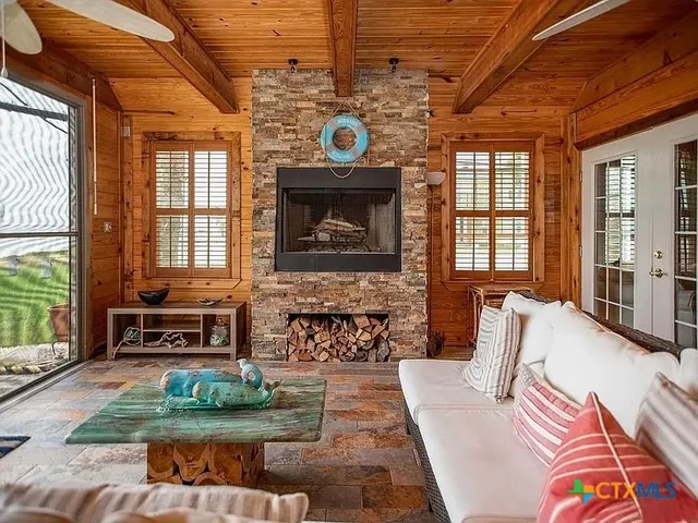 a living room with furniture and a fireplace