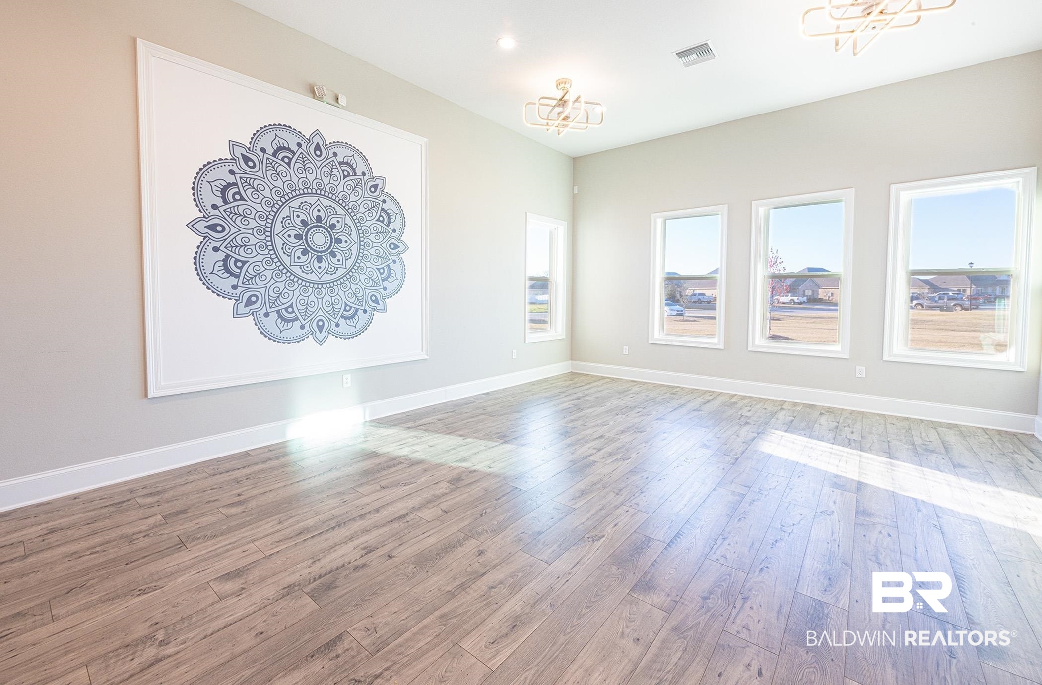 11044 Native Dancer Way Daphne, AL 36526 - Photo 67 of 67 Unfurnished living room with hardwood / wood-style flooring and a chandelier