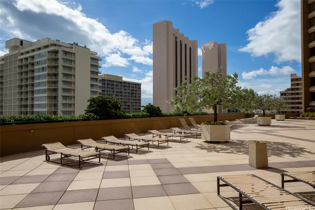 a view of a patio with couches and potted plants