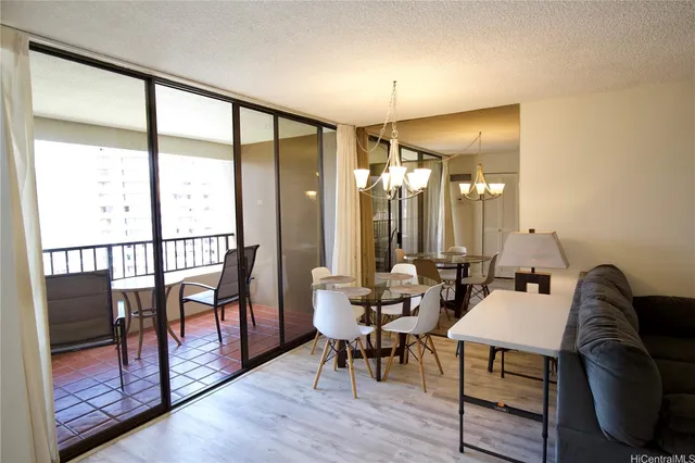 a living room with furniture a lamp and a floor to ceiling window