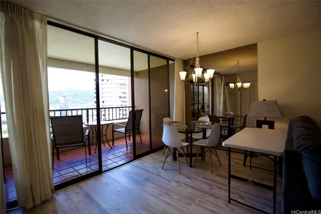 a view of a livingroom with furniture wooden floor and window