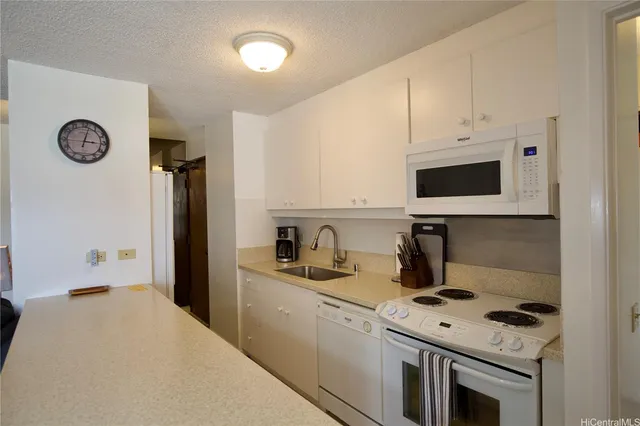 a kitchen with stainless steel appliances a stove a refrigerator a sink a stove and cabinets