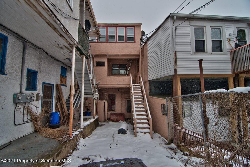 108 North Main Street Scranton, PA 18517 - Photo 15 of 16 a view of a house with blue walls stairs and a large tree