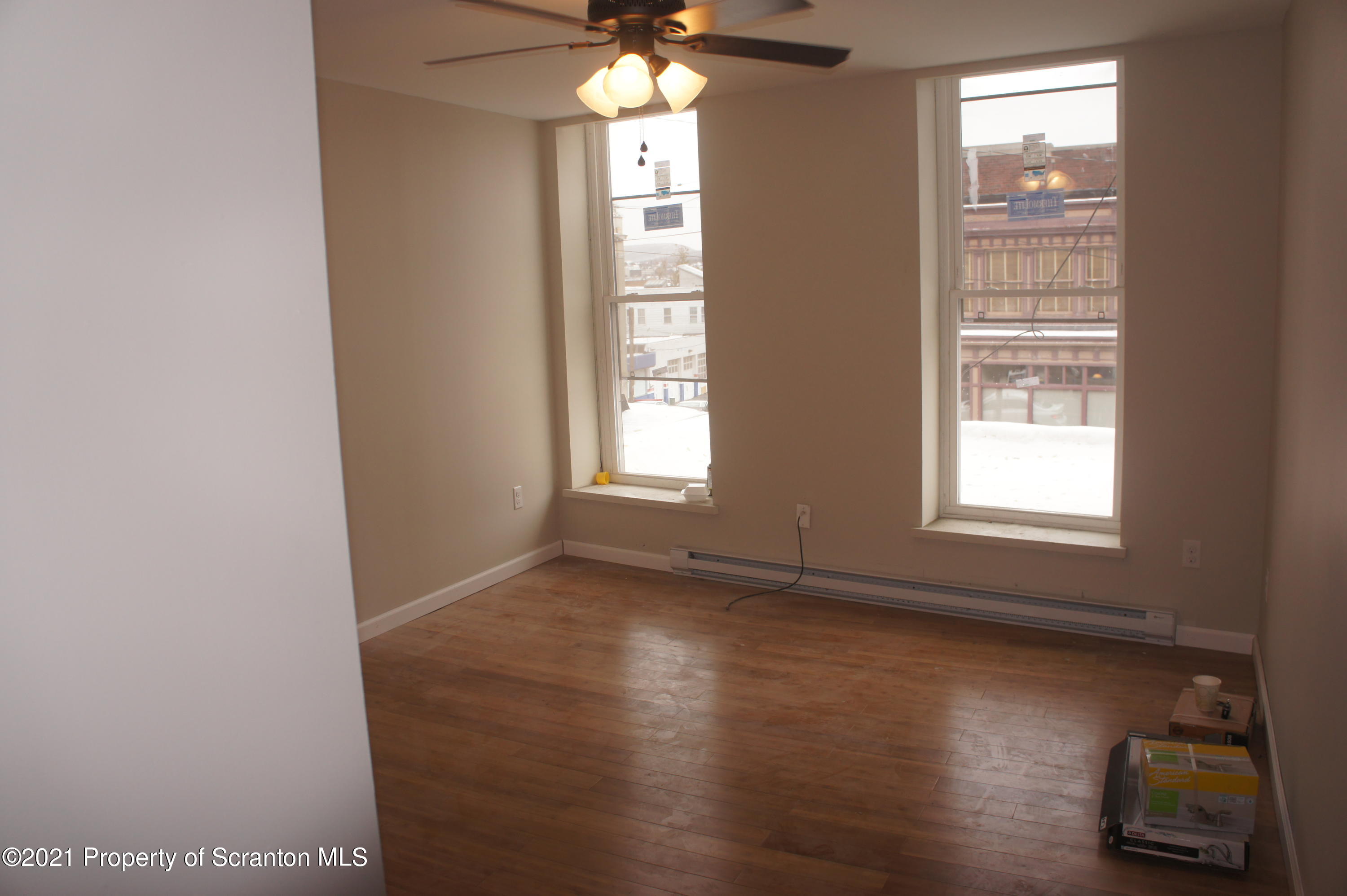 108 North Main Street Scranton, PA 18517 - Photo 9 of 16 an empty room with wooden floor and windows