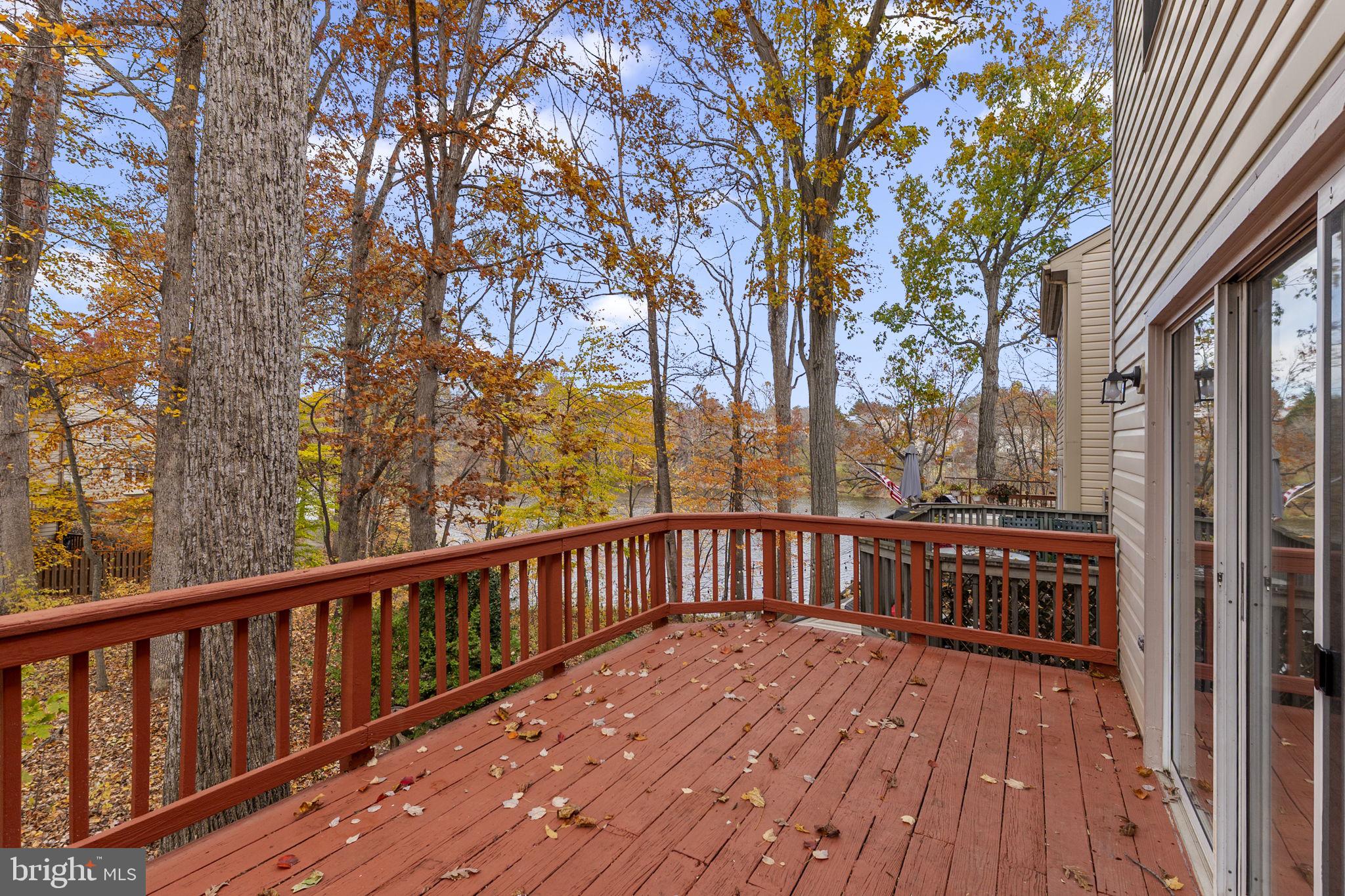 4 Waterside Court Germantown, MD 20874 - Photo 12 of 37 a view of a wooden deck with a trees