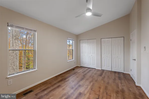 a view of an empty room with wooden floor