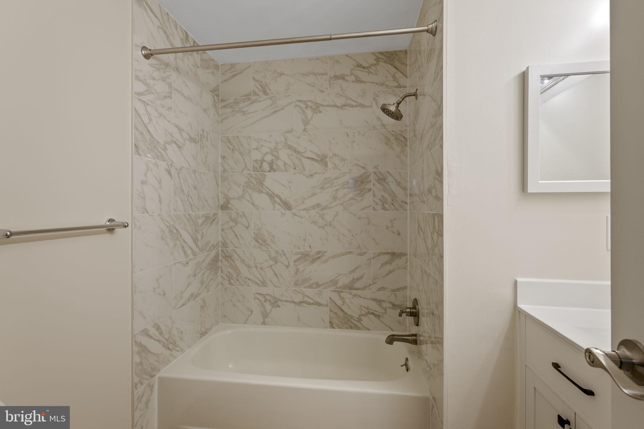 4 Waterside Court Germantown, MD 20874 - Photo 19 of 37 a bathroom with a shower and a bath tub