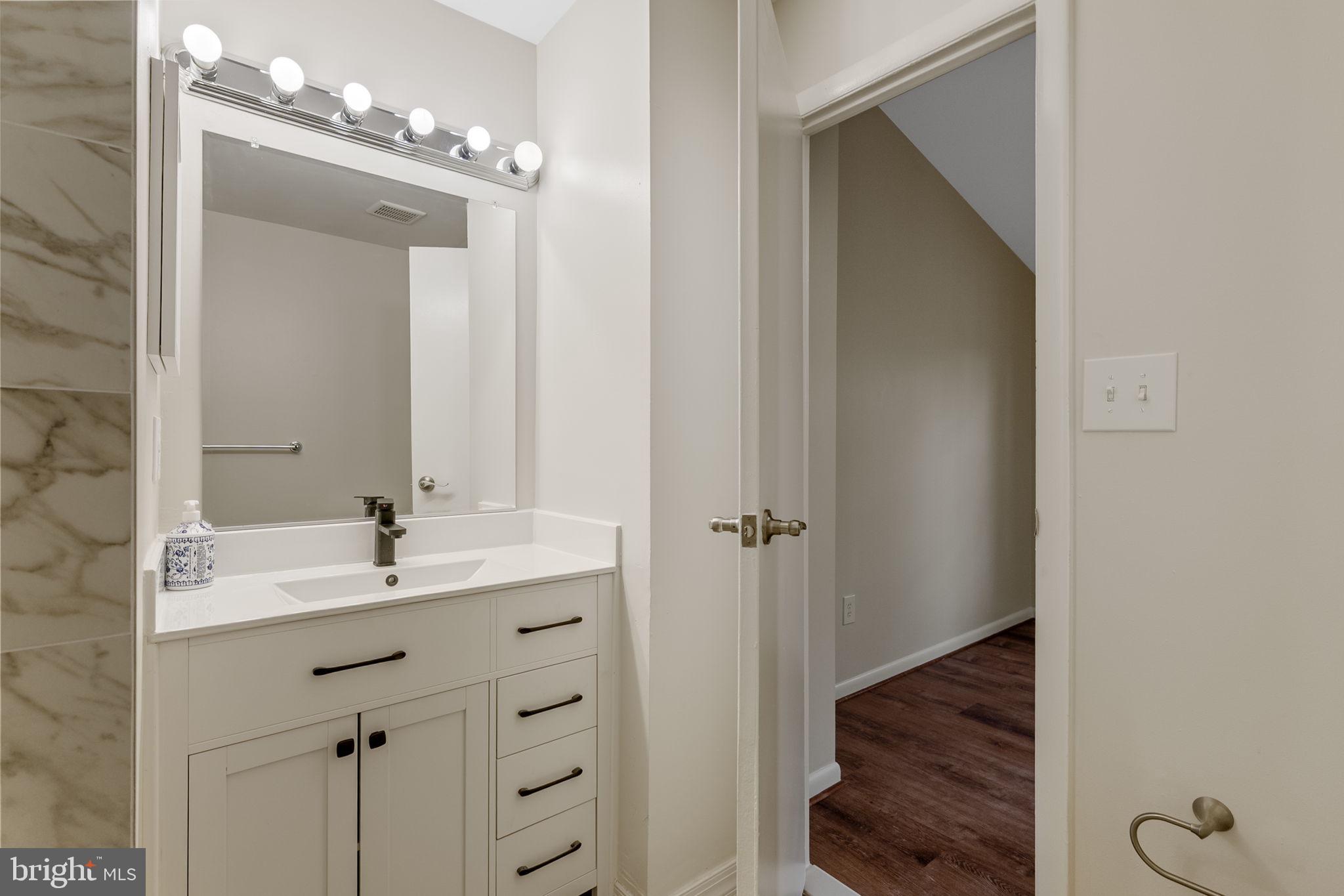 4 Waterside Court Germantown, MD 20874 - Photo 20 of 37 a bathroom with a double vanity sink and mirror