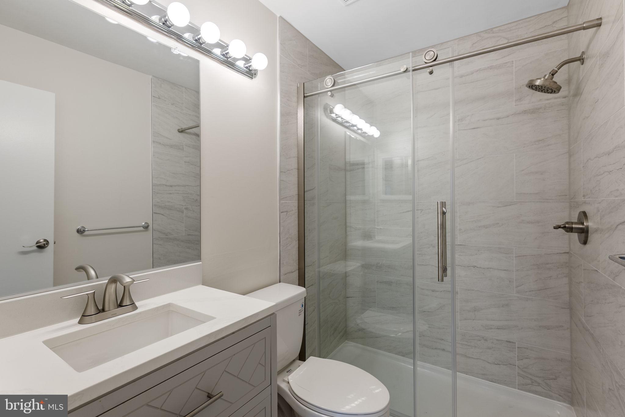 4 Waterside Court Germantown, MD 20874 - Photo 23 of 37 a bathroom with a sink toilet and shower